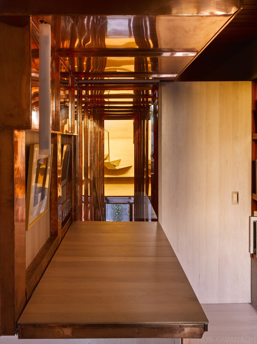 Interior view of adjustable counter showing copper stairway and open door