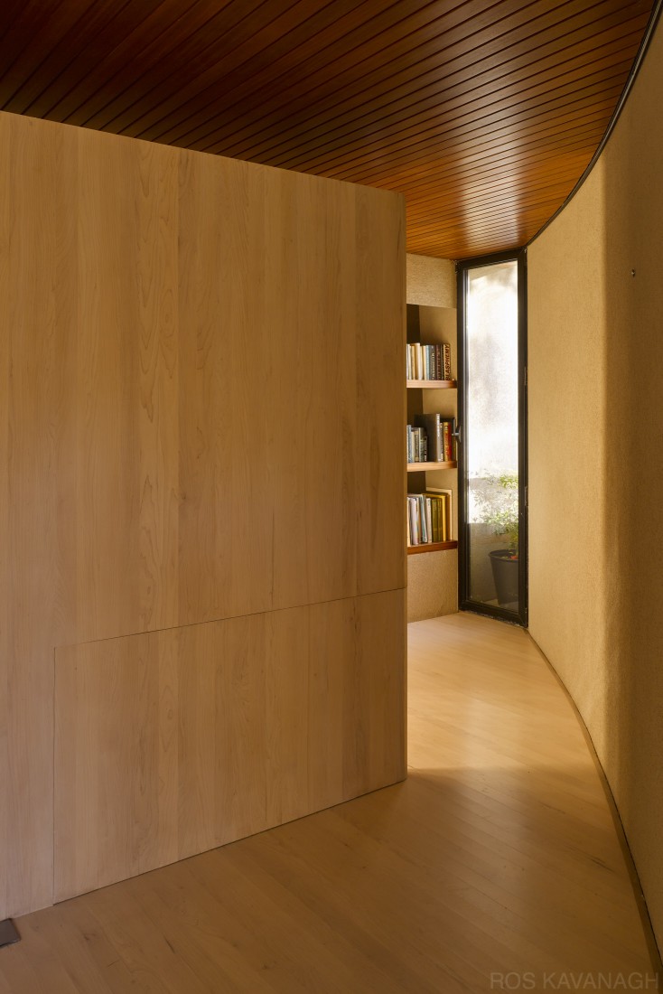 Interior view of living space showing curved wall with wall panel closed