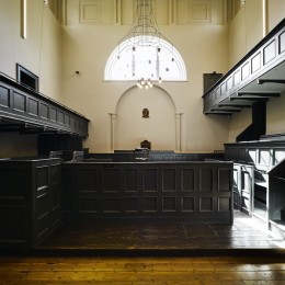 Interior view of court room showing benches and timber floor