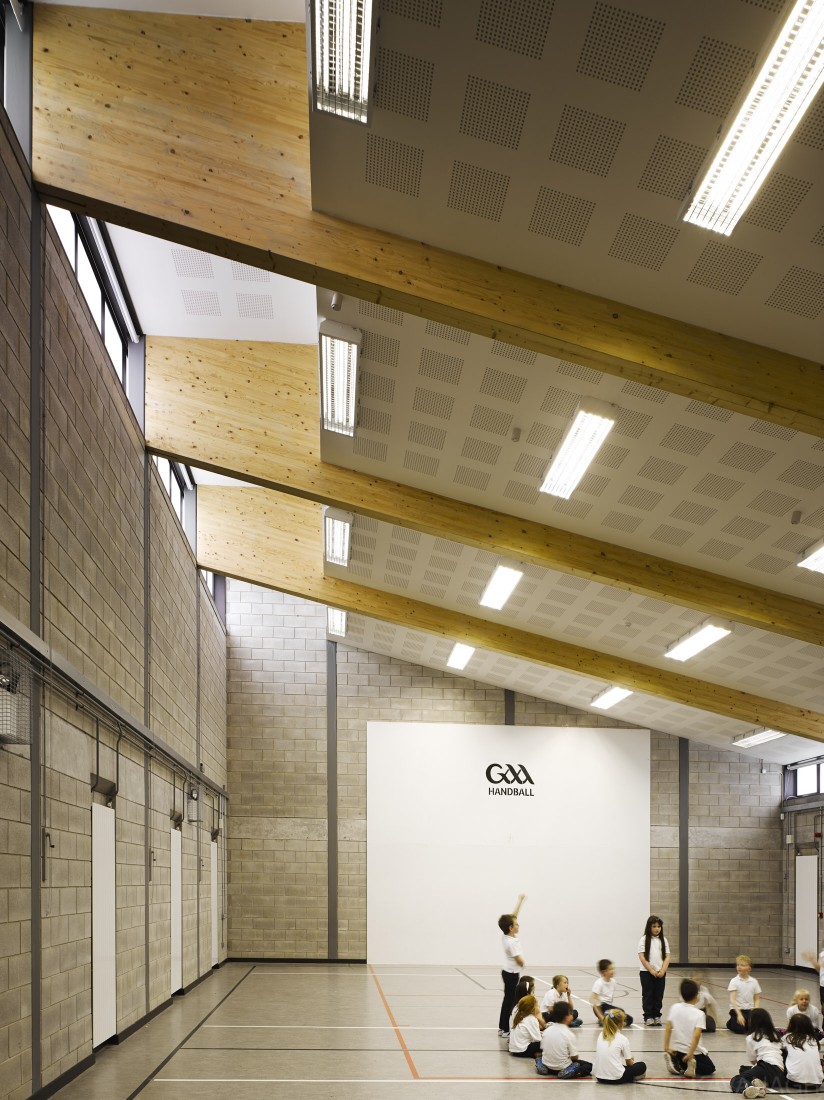 View of gymnasium showing timber beams and school children