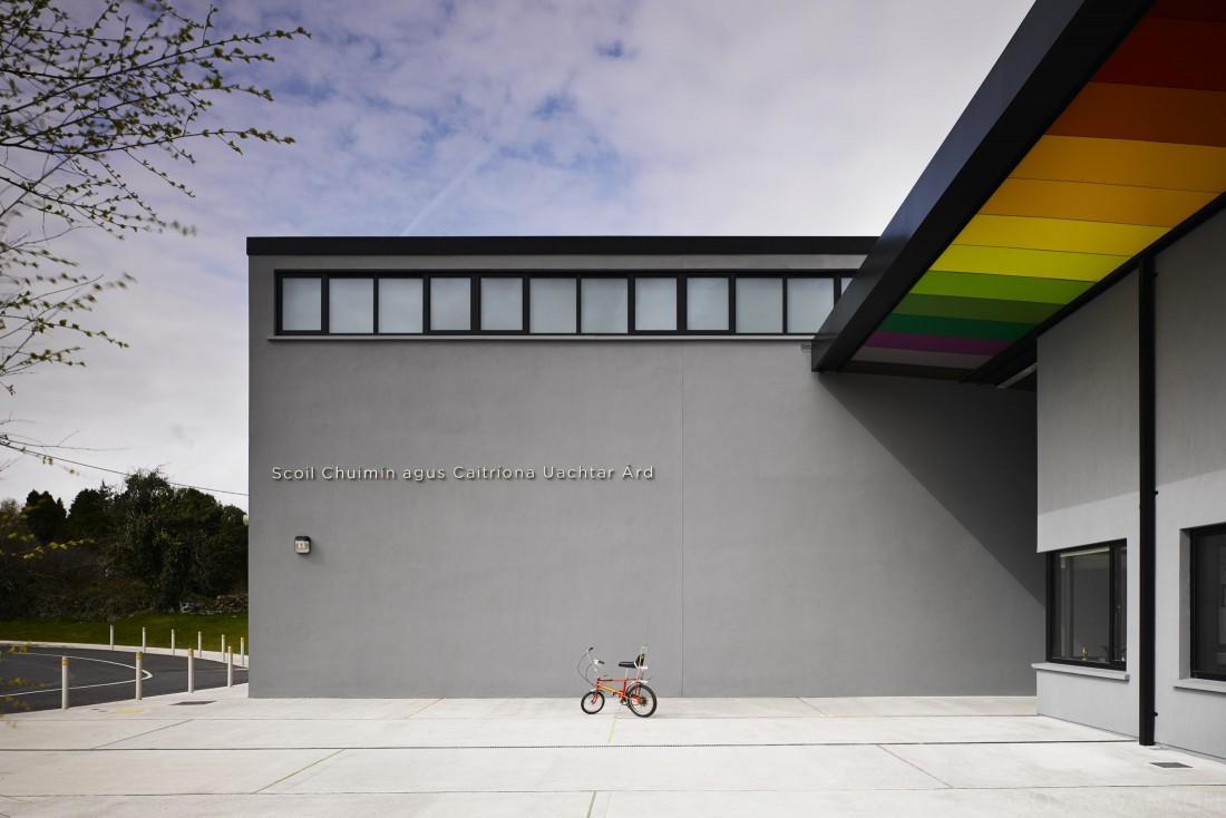 View of school entrance showing coloured soffit panels and bicycle