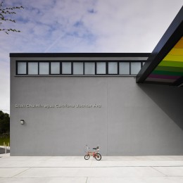 View of school entrance showing coloured soffit panels and bicycle