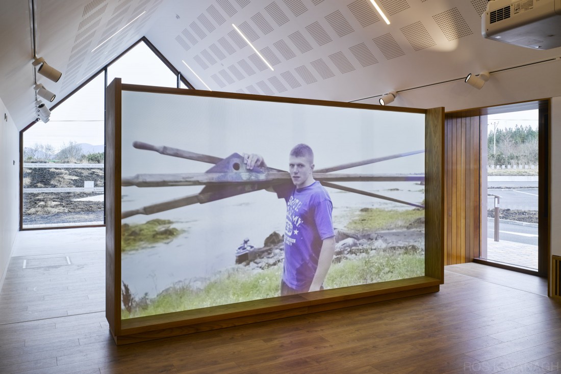 Interior view of exhibition space showing video on gaeltacht life